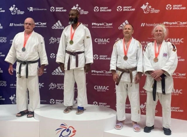 photo of Bryan at British masters receiving his bronze medal